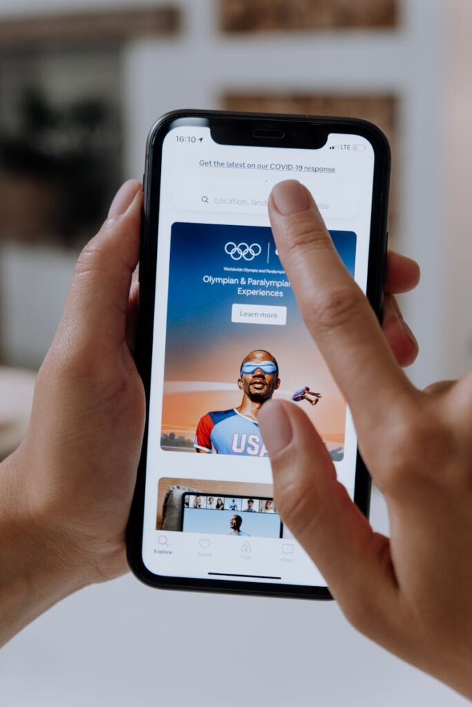 pexels-photo-5077061-5077061 Close-up of hands interacting with a smartphone displaying an e-commerce platform.