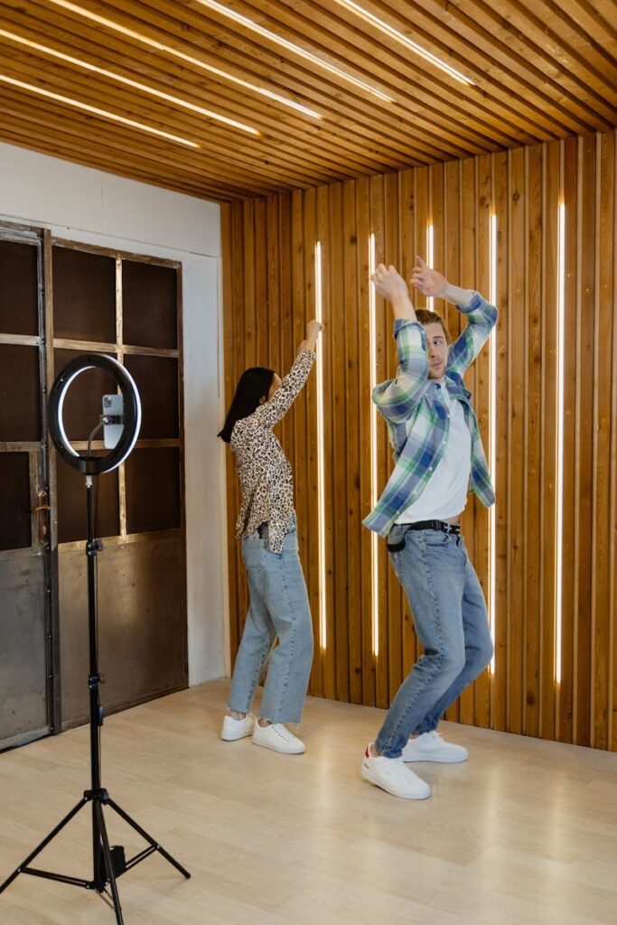 pexels-photo-7480546-7480546 Energetic couple dances in modern living room, creating content for social media.